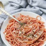 This gluten free red wine pasta + garlic basil goat cheese sauce is the perfect quick and fancy date night recipe that's ready in under 20 minutes! The gluten free pasta is cooked and stained in red wine and then tossed in a creamy garlic basil goat cheese sauce.