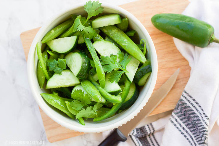 This easy spicy cucumber salad is sweet and spicy, tangy and smooth, simple and healthy. It hits all the right spots with all the right flavors and takes less than 5 minutes to make!
