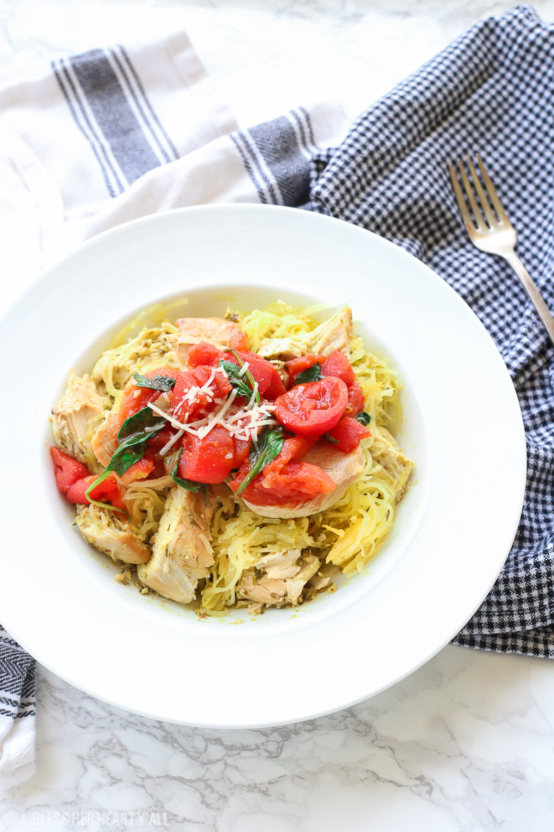 This spinach tomato spaghetti squash recipe combines fresh fluffy spaghetti squash and tops it with an easy and quick spinach and tomato sauce that's so garlicky and savory, the perfect combination of a healthy tasty meal!