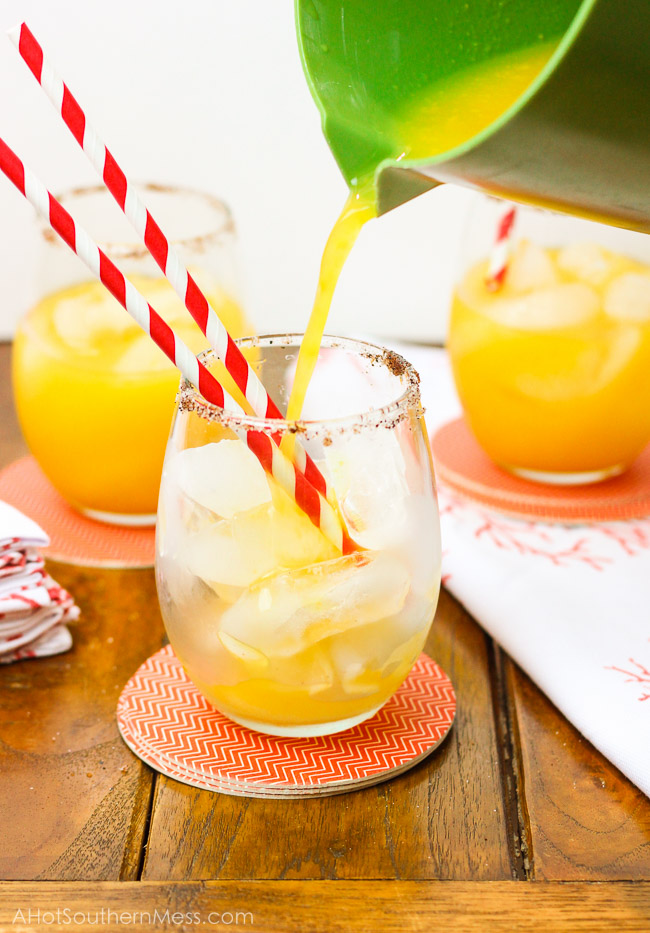 A sweet refreshing twist on summer lemonade. The fusion of mango and chili powder along with a splash of hot sauce, add a fun spicy summer twist {oh, and did I forget to mention the chili powder and sugar-laced rims? How dare me???}. And for those of us 21 or older, the addition of white rum makes this sipping cocktail a fruity delight! www.ahotsouthernmess.com