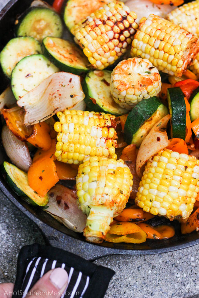 What an easy and healthy recipe! These fresh sweet veggies are placed on the grill in a cast iron skillet, drizzled with olive oil and sriracha, and then sprinkled with more fire with crushed red pepper flakes, before being toasted to perfection. The end result is sweet and spicy tender veggies with a hint of the grill and a bit of crispity crunch. www.ahotsouthernmess.com