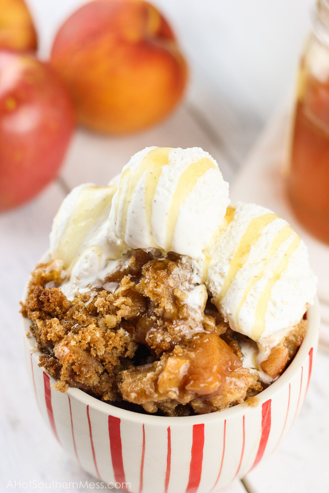 This gluten-free apple crumble is a favorite fall treat. Crisp apples are mixed with sweet end-of-season peaches as a base. Cinnamon, brown sugar, gluten-free oats, and lemon juice are combined with a bit of sweet cream butter, to finish off the candy-like crumble topping. Serve right out of the oven with soft vanilla bean ice cream and a fresh honey drizzle. www.ahotsouthernmess.com