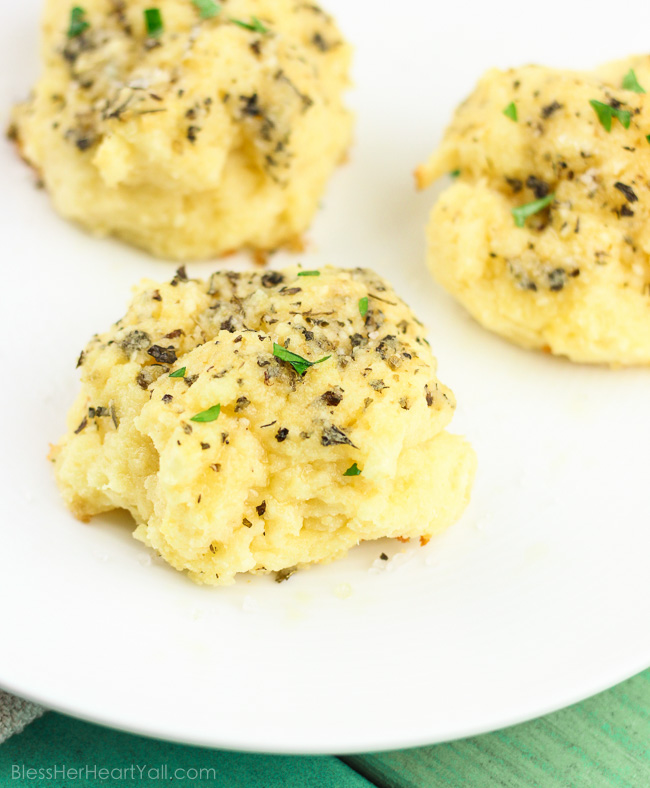 Soft gooey rolls that are topped with a fresh garlic butter sauce then sprinkled with parmesan and coarse sea salt and then smothered in garlic butter once again. These gluten-free bites are a quick and easy game-changer for any meal that they are served with! www.blessherheartyall.com