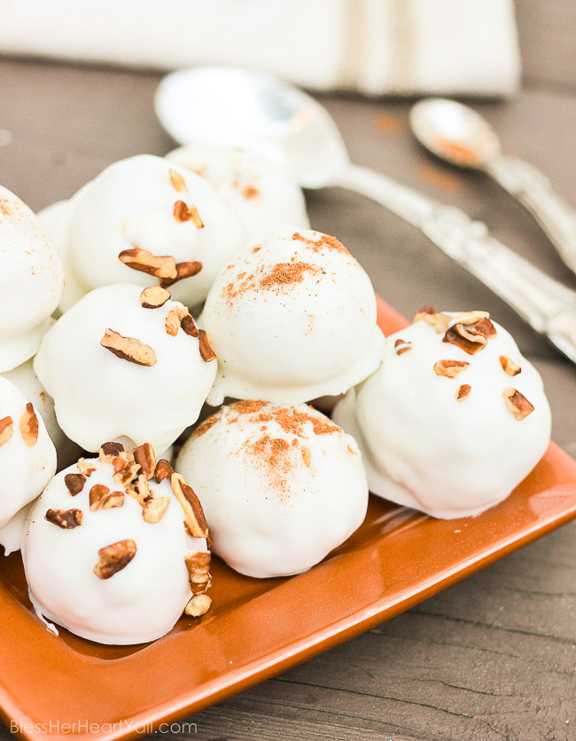 These pumpkin pecan truffles have smooth creamy pumpkin centers with pecan pieces hidden inside. The white chocolate coating is drizzled overtop and more pecan pieces sprinkled for the finale. Perfect no-bake party treats that can be quickly made! www.blessherheartyall.com