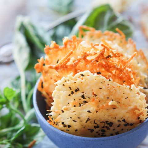 Garlic basil parmesan crisps are an easy 3 ingredient baked recipe! These great dippers are perfect appetizers or snacks for any gluten-free or low carb eaters and are huge hits at parties! All you need is parmesan, basil, garlic powder and 5 minutes beside your oven! www.blessherheartyall.com