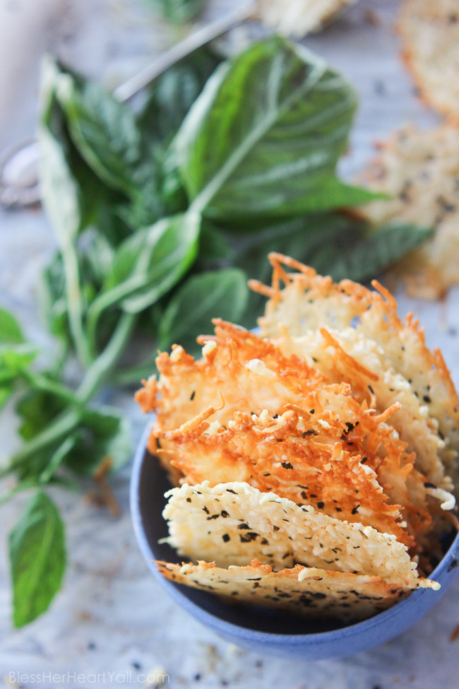 Garlic basil parmesan crisps are an easy 3 ingredient baked recipe! These great dippers are perfect appetizers or snacks for any gluten-free or low carb eaters and are huge hits at parties! All you need is parmesan, basil, garlic powder and 5 minutes beside your oven! www.blessherheartyall.com