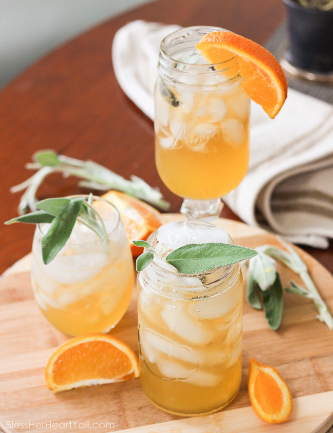 This honey bear cocktail is the perfect cocktail to sip on during those chilly fall evenings with friends on your porch or for entertaining those guests as they walk in the front door of your Thanksgiving day festivities. Made with a simple syrup of honey, sage, and orange, then combined with southern bourbon over ice, you will be sipping on a fresh, mellow, slightly sweet cocktail that everyone {including those honey bears!} will find perfect all fall long. www.blessherheartyall.com