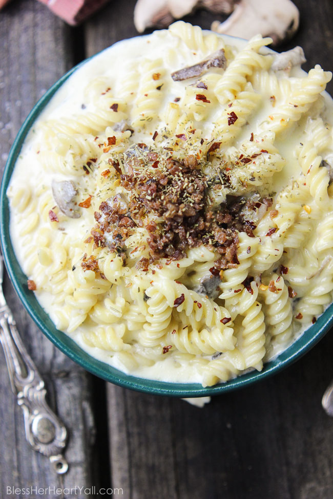 This spicy gluten-free mac and cheese recipe will blow your socks off in under 30 minutes! Let's combine bacon, mushrooms, truffle oil, some heat, and mac and cheese, shall we? Then we will create spicy, creamy, cheesy perfection. www.blessherheartyall.com