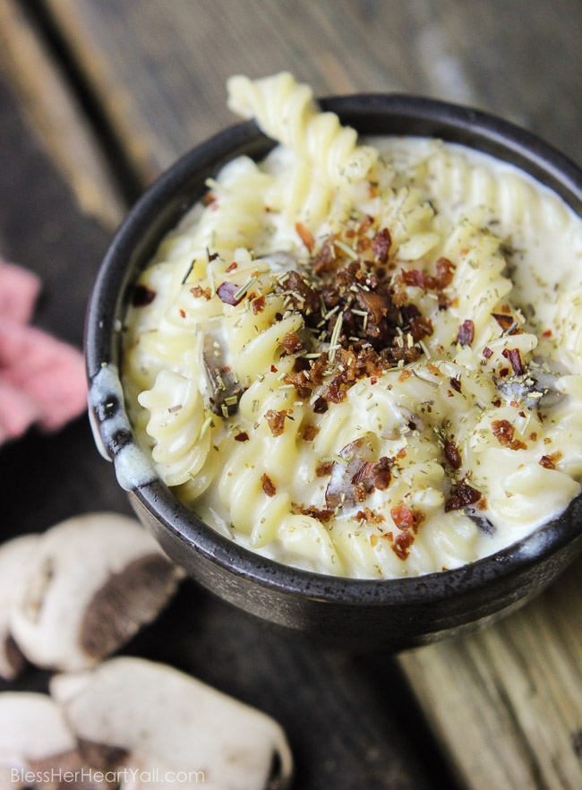 This spicy gluten-free mac and cheese recipe will blow your socks off in under 30 minutes! Let's combine bacon, mushrooms, truffle oil, some heat, and mac and cheese, shall we? Then we will create spicy, creamy, cheesy perfection. www.blessherheartyall.com