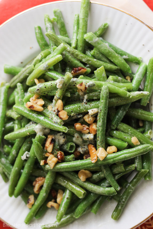 easy bleu cheese green beans Fresh green beans are prepared {can be prepared in TWO ways!} with a decadent blue cheese sauce drizzled and stirred over top for a warm, hearty, cheesy, creamy addition to your holiday table. And the best part? It will look like you had been in the kitchen sweating to make this dish happen, when in reality… it was soooooo easy-peasy. | www.blessherheartyall.com|