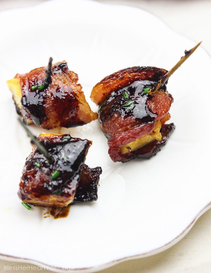 These bacon wrapped pineapple with sriracha lime glaze bites are an easy to-put-together appetizer for any party! Juicy pineapple is wrapped up in thick-cut applewood smoked bacon and then drizzled with a sriracha lime glaze before being baked in the oven to sweet and savory perfection! Yum! www.BlessHerHeartYall.com