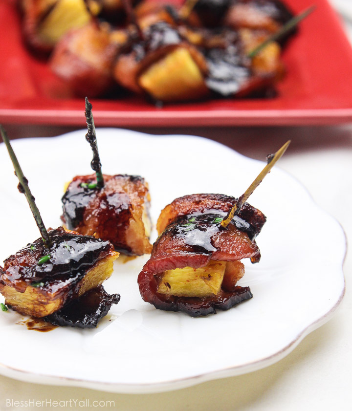These bacon wrapped pineapple with sriracha lime glaze bites are an easy to-put-together appetizer for any party! Juicy pineapple is wrapped up in thick-cut applewood smoked bacon and then drizzled with a sriracha lime glaze before being baked in the oven to sweet and savory perfection! Yum! www.BlessHerHeartYall.com