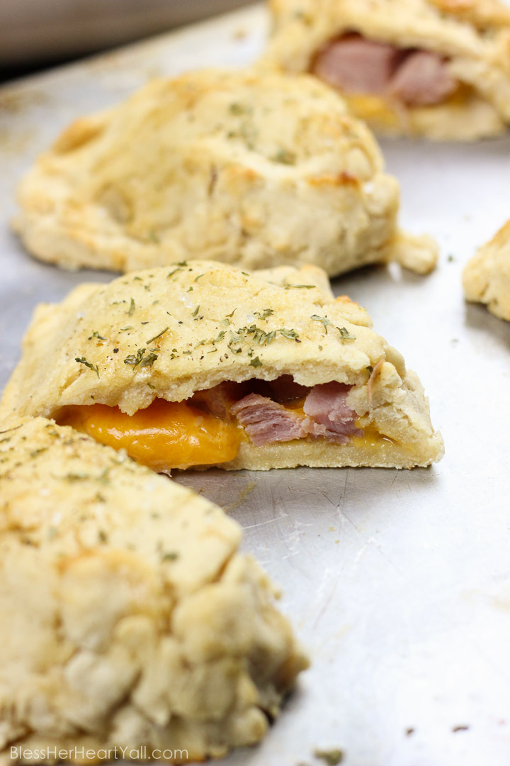 These gluten-free ham and cheese hot pockets are the real deal! Perfectly crispy pockets of smooth soft dough are stuffed with leftover Christmas ham and melty cheese, closed up, and brushed with an olive oil, honey, brown sugar, and garlic sauce. It's the perfect tasty meal on-the-go and a great way to finish off those Christmas ham leftovers! www.blessherheartyall.com