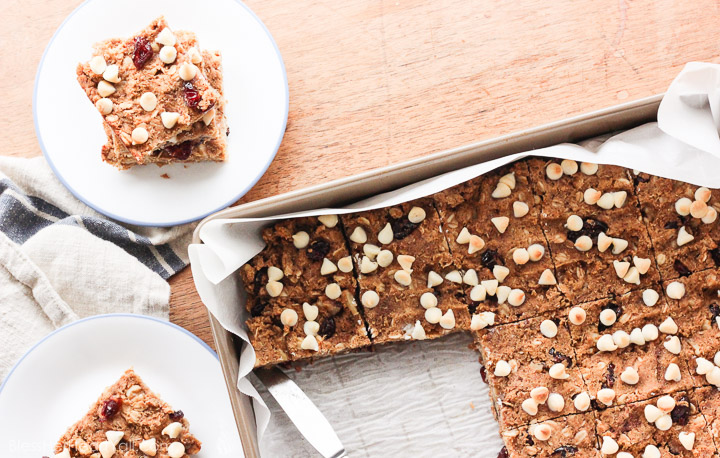 These gluten-free quinoa breakfast bars are a sweet and easy breakfast option for those on-the-go mornings. These breakfast / protein bars combine quinoa, coconut flour, honey, and peanut butter with dried fruits and white chocolate chips to make a delicious baked gluten-free breakfast! www.BlessHerHeartYall.com