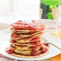 These gluten-free pancakes with smashed strawberry sauce recipe is one for the books! The pancakes are light and fluffy (and yes, I promise are gluten-free!) with a touch of coconut's sweetness. The smashed strawberry champagne sauce is a fun topper, with strawberries, lemon juice, and champagne caught up together in a thick, warm syrupy sauce to smother your pancakes in! Breakfast is now the best meal of the day! | BlessHerHeartYall.com |