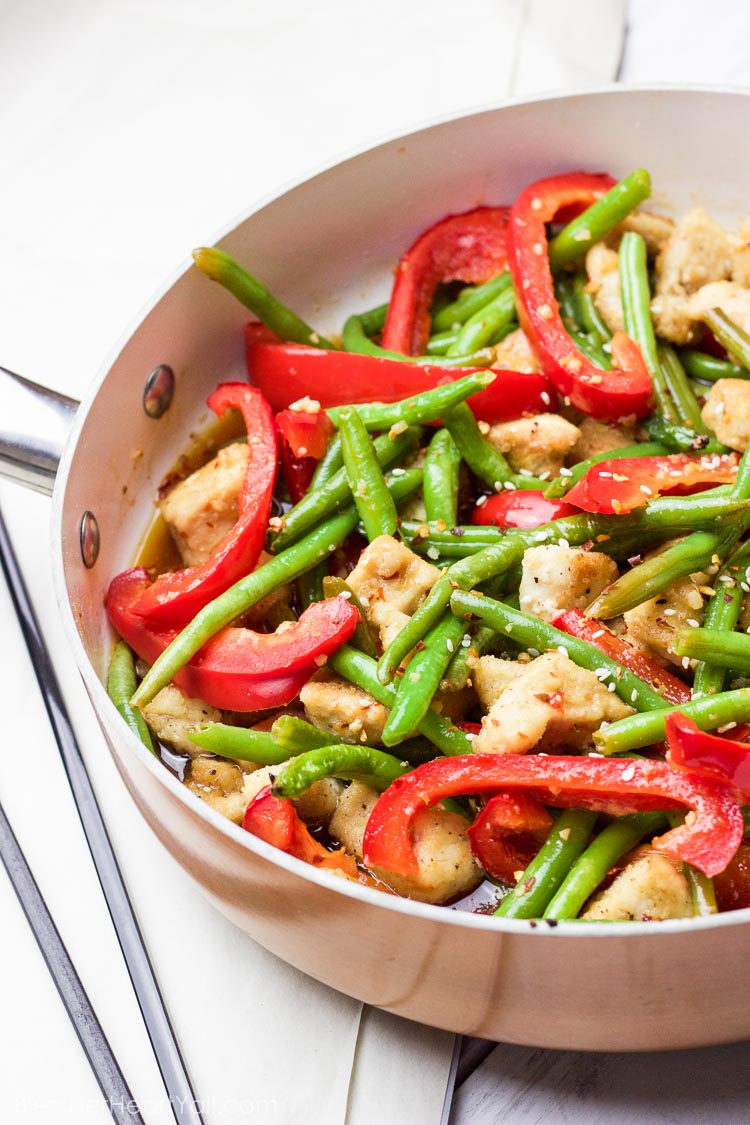 This 30 minute coconut sesame chicken and green beans skillet is a tasty and fresh dish that combines coconut oil, fresh honey, chili flakes, and garlic and then drizzled over fresh chicken and green beans and baked to tender perfection!
