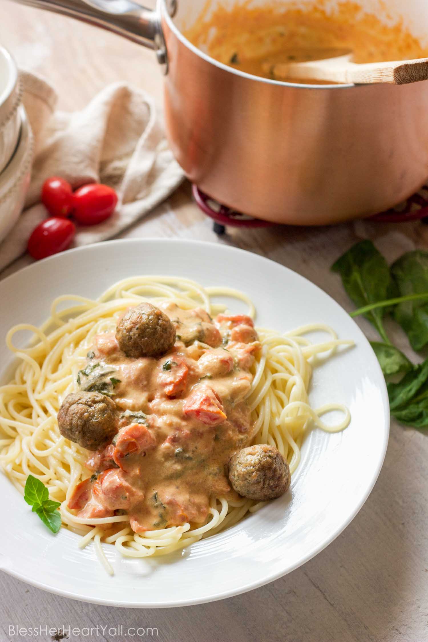 This easy goat cheese spaghetti and meatballs recipe combines fresh goat cheese, smashed tomatoes, and fresh basil, garlic, and onion for a delicious meal in less than 20 minutes!