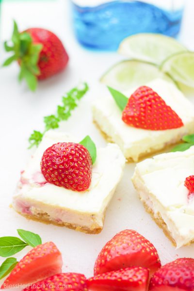 These gluten-free strawberry basil margarita cheesecake squares are the ultimate refreshingly sweet party carb. With hints of lime and a splash of tequila, along with fresh chopped basil and strawberries, these cheesecake bites will blow your mind with every sweet and zesty bite!
