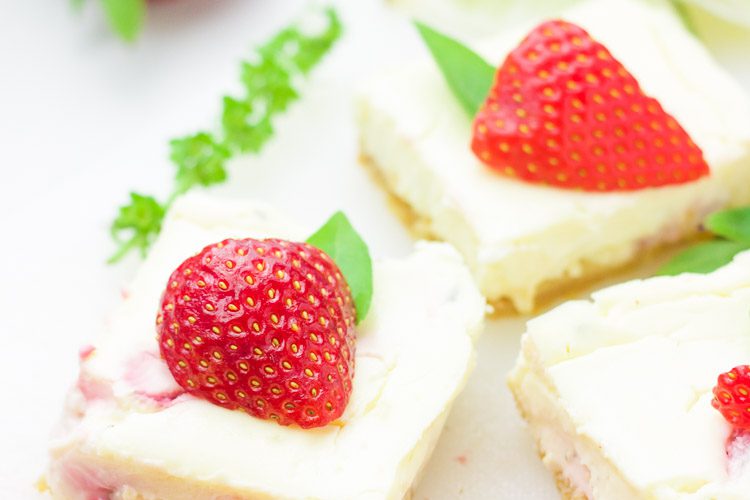 These gluten-free strawberry basil margarita cheesecake squares are the ultimate refreshingly sweet party carb. With hints of lime and a splash of tequila, along with fresh chopped basil and strawberries, these cheesecake bites will blow your mind with every sweet and zesty bite!