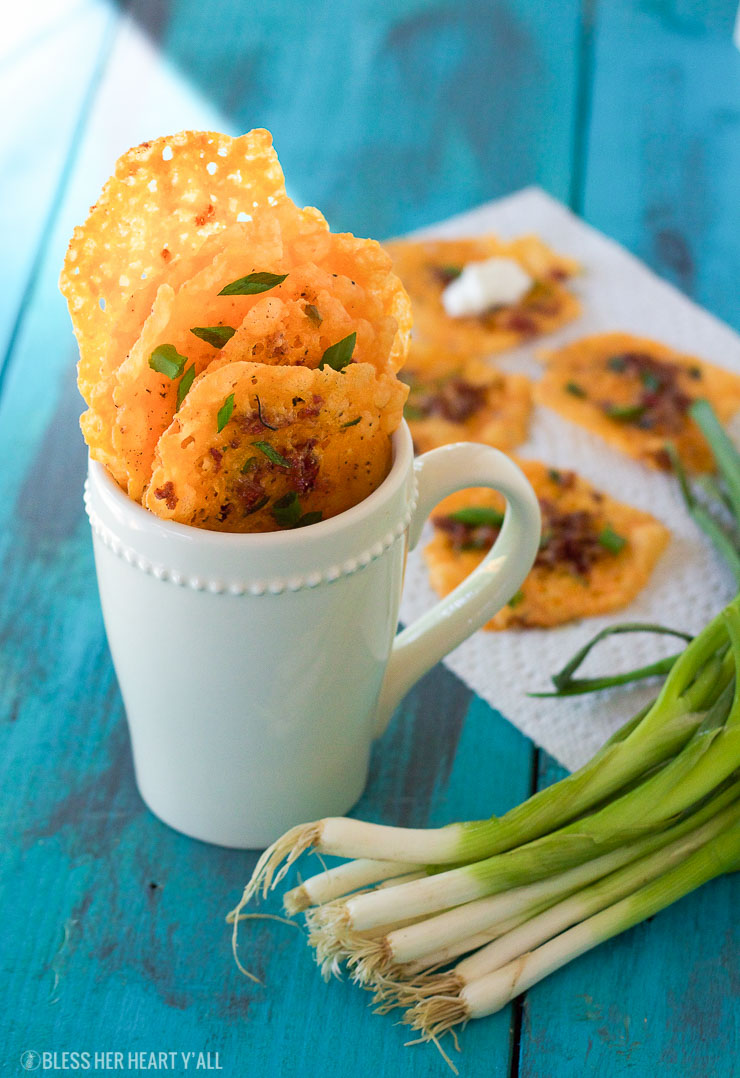 Loaded bacon cheddar crisps are the perfect 5 ingredient baked finger food for your next party! They combine cheddar, bacon, garlic, and green onion into a gluten-free and low carb snack that takes just minutes to make! Place a dollop of sour cream on them and you have a new easy low carb version of loaded potato skins!