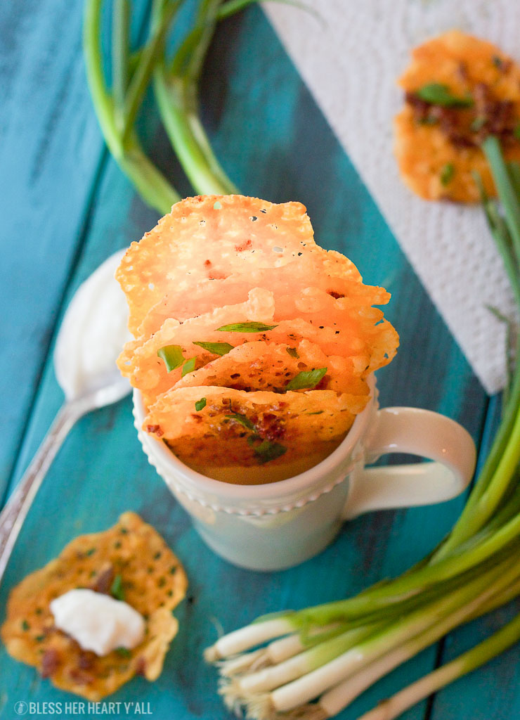 Loaded bacon cheddar crisps are the perfect 5 ingredient baked finger food for your next party! They combine cheddar, bacon, garlic, and green onion into a gluten-free and low carb snack that takes just minutes to make! Place a dollop of sour cream on them and you have a new easy low carb version of loaded potato skins!