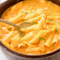 This gluten-free pumpkin mac and cheese recipe is the ultimate cheesy fall comfort food. Gluten-free noodles are cooked in a pumpkin, sage, and nutmeg sauce and just before serving are smothered in gooey cheddar and parmesan cheeses.