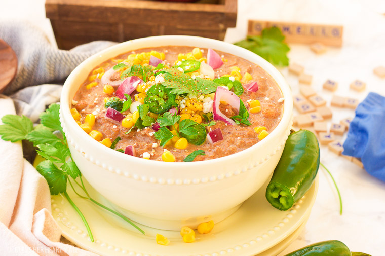 This slow cooker white turkey chili combines juicy leftover roasted turkey, chunky vegetables, and garlic, oregano, paprika, and spice to make a delicious stick-to-your-ribs meal that's so simple to make and so comforting to eat! It's also gluten free, dairy free and low carb! www.blessherheartyall.com