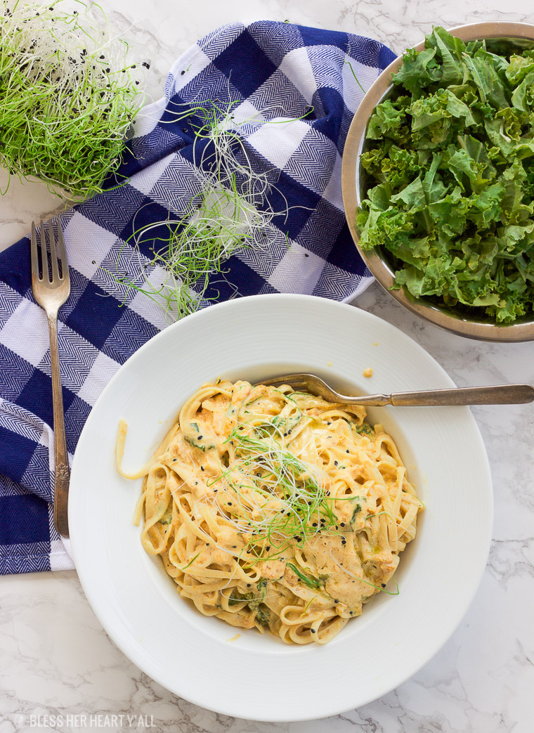 This vegan butternut squash pasta with kale and onion sprouts recipe is not only a showstopper, but it's packed full of nutrients and is also gluten-free, grain free, dairy free, and paleo friendly. Dive into this creamy savory dish in under 15 minutes! www.BlessHerHeartYall.com