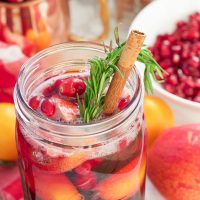 This winter pomegranate cranberry Christmas sangria recipe is a quick and easy twist on the popular sangria drink. Impress everyone at your next holiday or Christmas party with this sparkling red wine cocktail with apples, oranges, pomegranate, cranberry, rosemary, and cinnamon sticks! Get your drink on fancy pants!