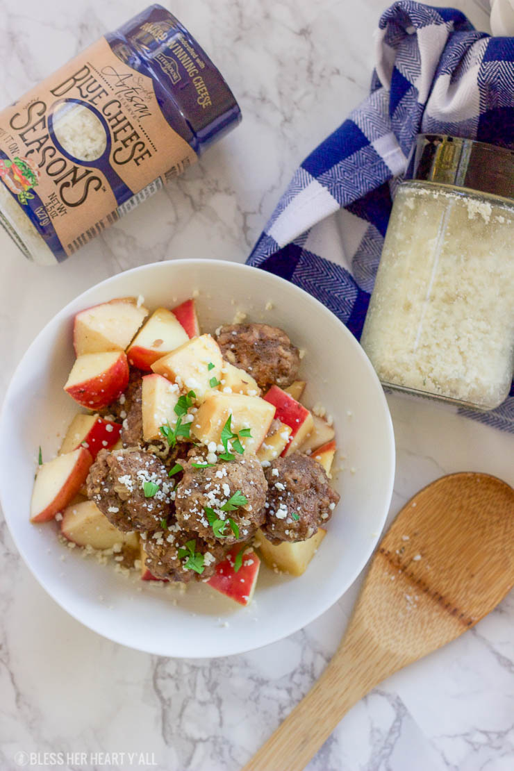 This easy slow cooker apple cider meatball recipe dunks fresh meatballs and juicy apple slices in apple cider, garlic, and blue cheese crumbles for a delicious fall spin. Bring them to a fall party and they will be gone in seconds! www.BlessHerHeartYall.com