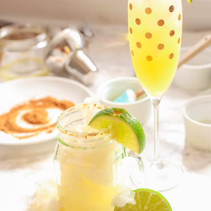 These skinny champagne margaritas are epicly delicious and prepared two different ways. There is no need for sugar or simple syrup for this recipe that uses a combination of fresh lime and orange juices as well as honey to sweeten and packs a punch with it's tequila and champagne, perfect for any New Year's Eve fiesta!