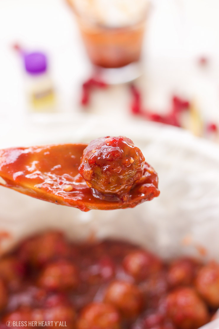 These spicy cranberry bacon bbq meatballs are the ultimate in sticky finger foods just in time for the holidays! A quick homemade cranberry sauce is melted and smothered into barbecue sauce and hot spices for the perfect sweet and spicy no-fuss pop-able party bites!