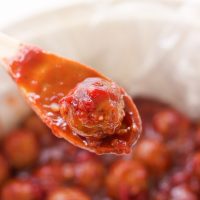 These spicy cranberry bacon bbq meatballs are the ultimate in sticky finger foods just in time for the holidays! A quick homemade cranberry sauce is melted and smothered into barbecue sauce and hot spices for the perfect sweet and spicy no-fuss pop-able party bites!