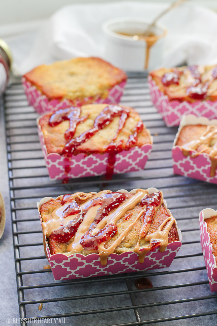 Moist gluten free mini peanut butter + jelly banana bread loaves are generously drizzled with Welch's Chia Strawberry Fruit Spread and all natural peanut butter for the perfect individualized breakfast!
