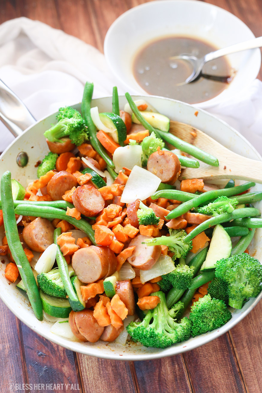 Sweet potato stir fry with chicken sausage slices are combined with fresh vegetables and a simple sweet and savory paleo stir fry sauce for one epically healthy meal your family will ask for time and time again.