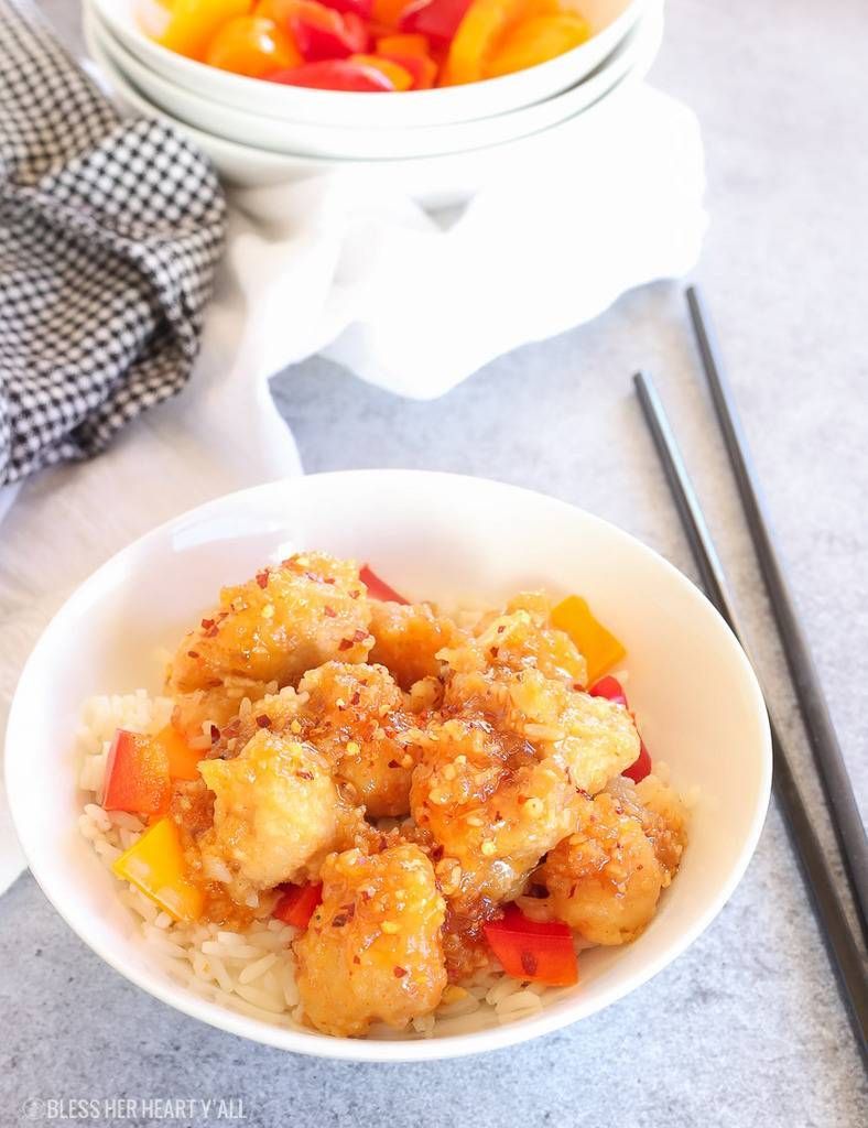 one-pan baked gluten-free General Tso’s chicken recipe on dinner table with chopsticks