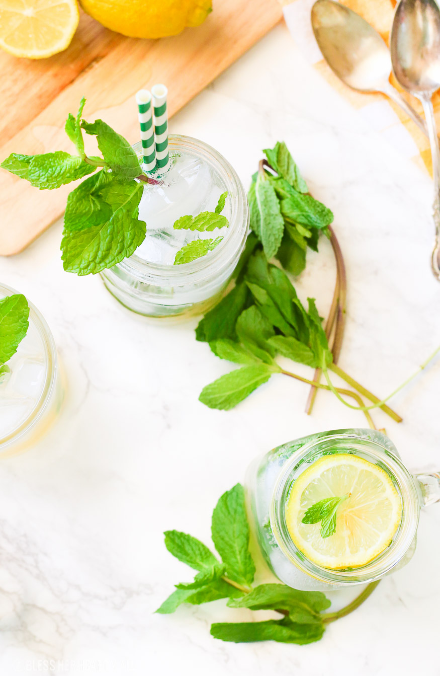 This lemonade mint julep recipe blends summer's most refreshing fresh squeezed lemonade and stirs it up into spring's hottest mint julep cocktail! Lemon, bourbon, mint, and sweet that's perfect for an outdoor party, watching the Kentucky Derby, or just a relaxing time outside on your back porch!