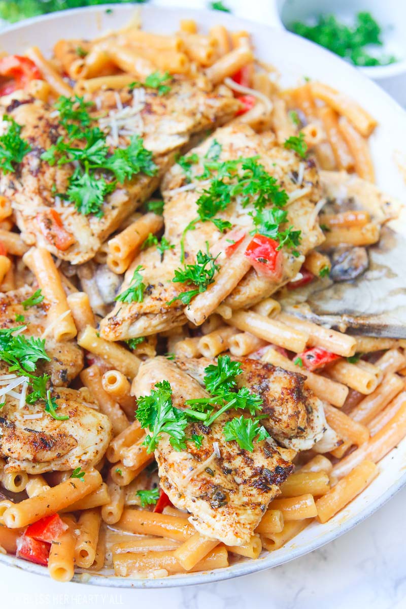 Cajun chicken pasta melts juicy cajun-seasoned chicken breasts with al dente gluten-free noodles in an easy creamy pasta sauce and sprinkled with extra gooey cheeses and herbs all in under 30 minutes! image 2