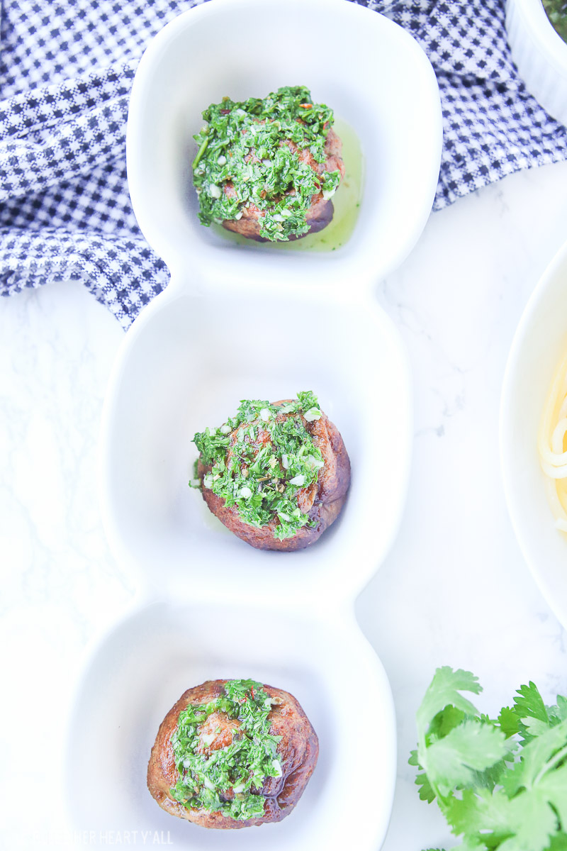 Chimichurri meatballs bake juicy bites of fresh beef and cilantro and then drizzle them with an easy homemade chimichurri sauce! This quick appetizer recipe is low carb, paleo, gluten free!