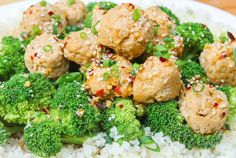 Sesame ginger paleo turkey meatballs bake soft paleo meatballs in a drizzle of homemade sweet and zesty sesame ginger sauce and topped with sesame seeds and green onion slivers. It's the perfect gluten-free, grain-free, and dairy-free appetizer or meal over rice and steamed vegetables! image 3