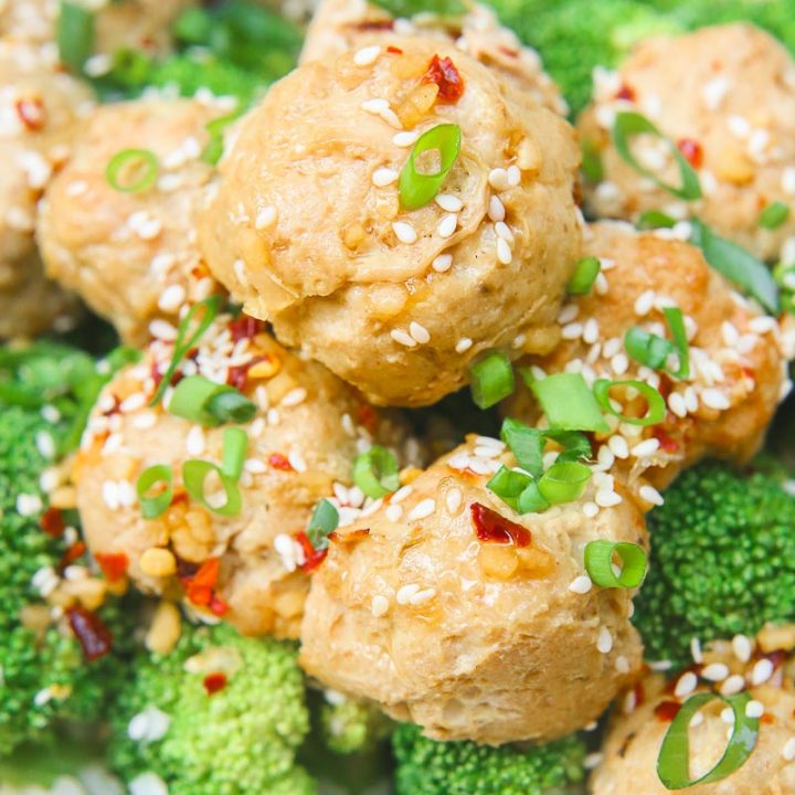 Sesame ginger paleo turkey meatballs bake soft paleo meatballs in a drizzle of homemade sweet and zesty sesame ginger sauce and topped with sesame seeds and green onion slivers. It's the perfect gluten-free, grain-free, and dairy-free appetizer or meal over rice and steamed vegetables! image 2