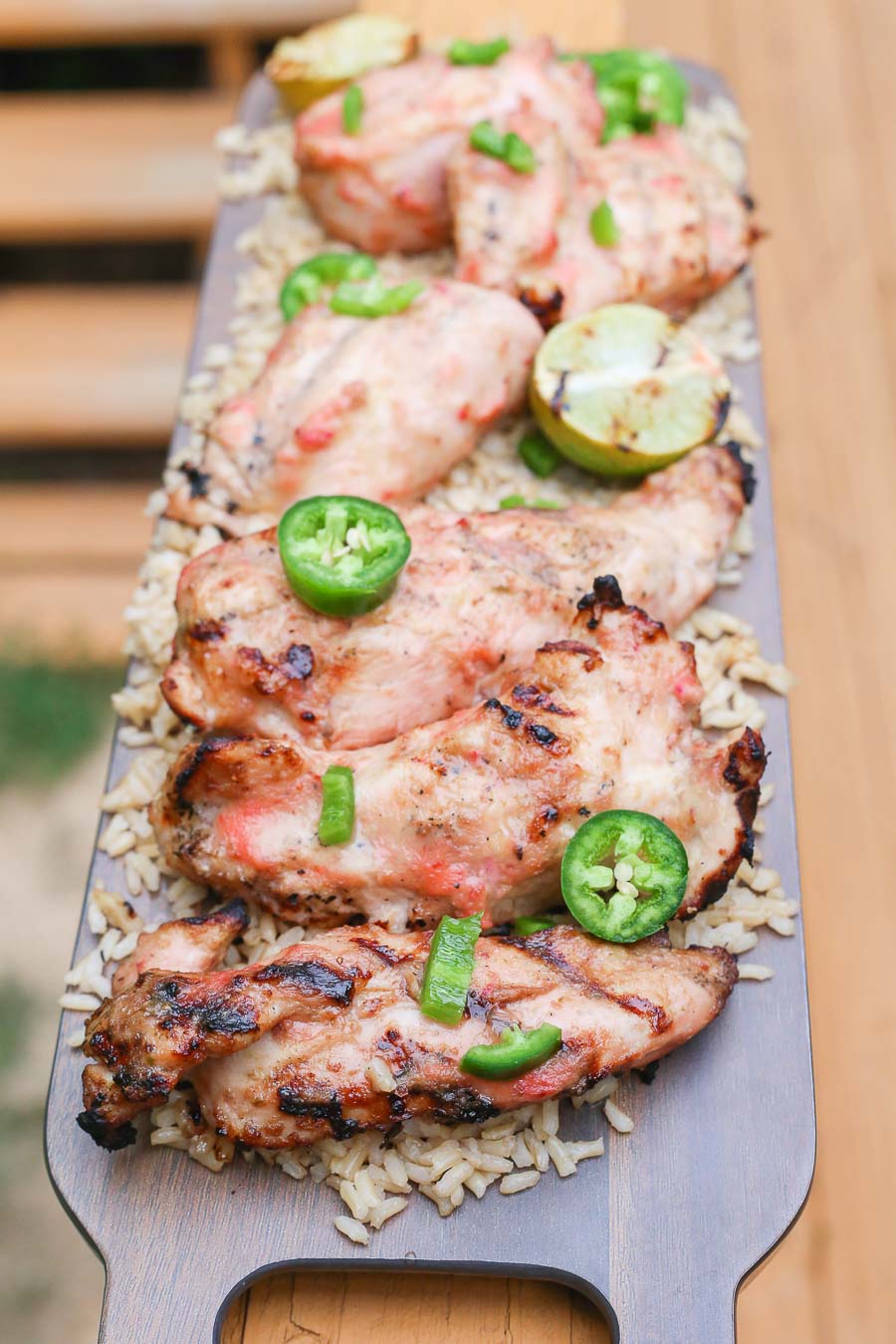 Grilled strawberry mango chicken with fresh jalapenos and grilled lime on a bed of fluffy brown rice!  This healthy delicious meal puts a light tropical flavor in every bite! image 1