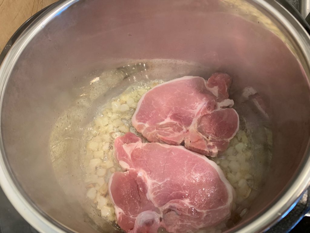 Saute and brown the pork chops and onions for Instant Pot Pork Chops