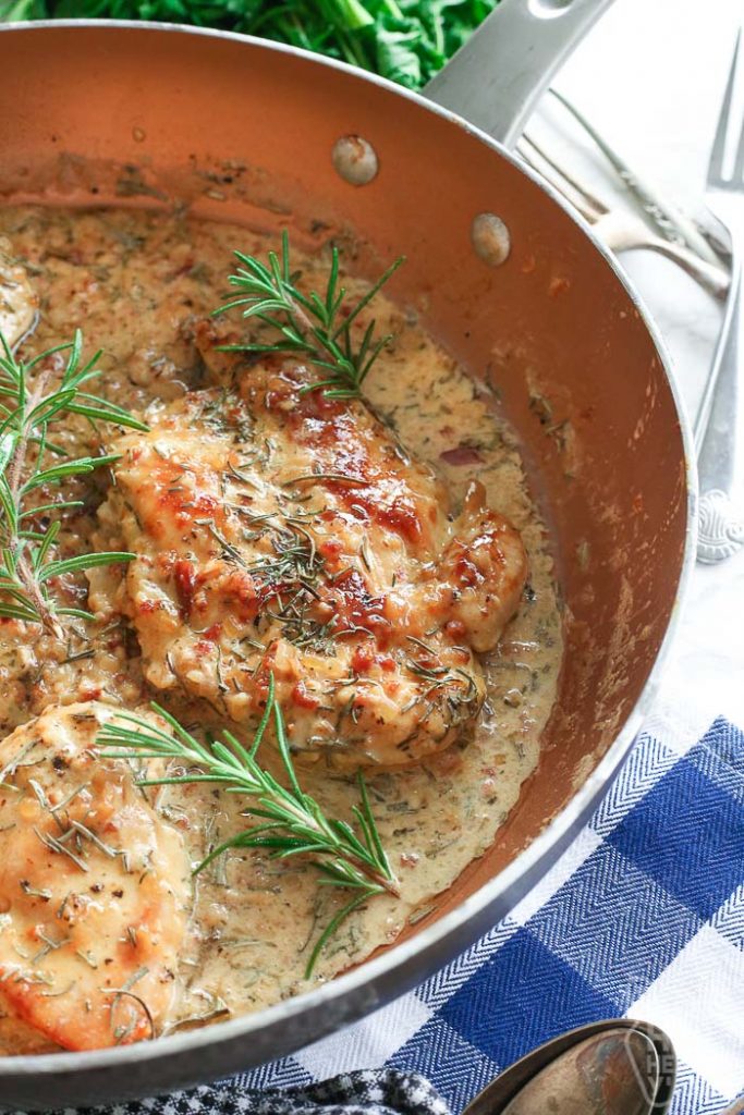 chicken breasts in white wine sauce that is thick and creamy in saucepan