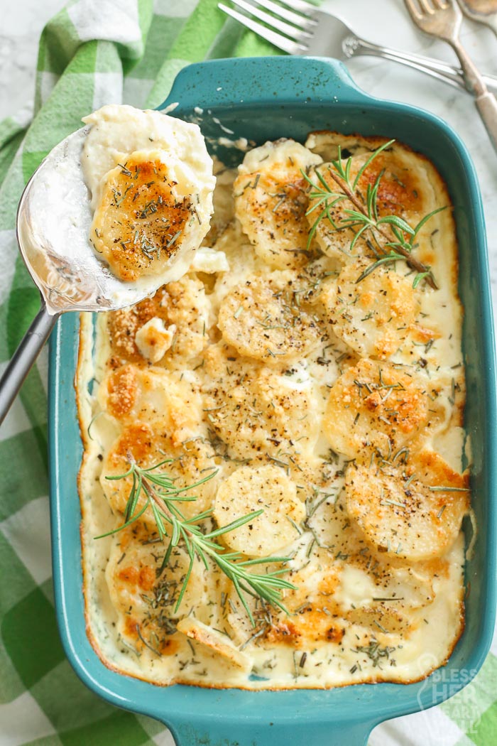 overhead shot of scalloped potatoes in dish and in serving spoon