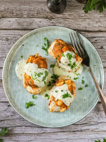 Chicken Chesapeake recipe, presented on a green plate on a wooden table